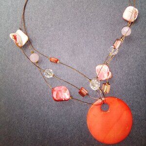 Womens natural pink stone beaded necklace with disc pendant.
